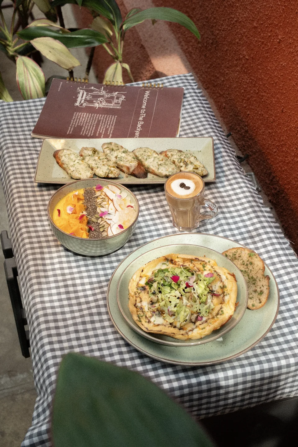 Pasta, coffee and snacks arranged on a café table