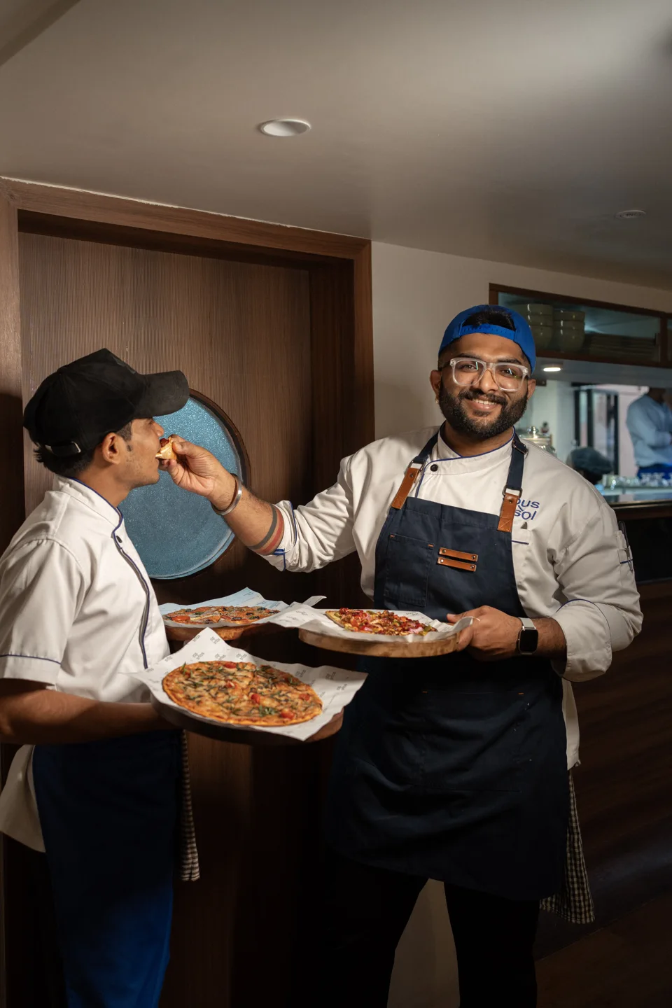 Two café team members sharing a moment behind the counter